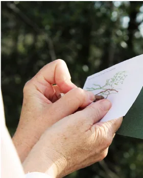 Hands holding an illustrated prompt card from the Map the Moment walking workshop